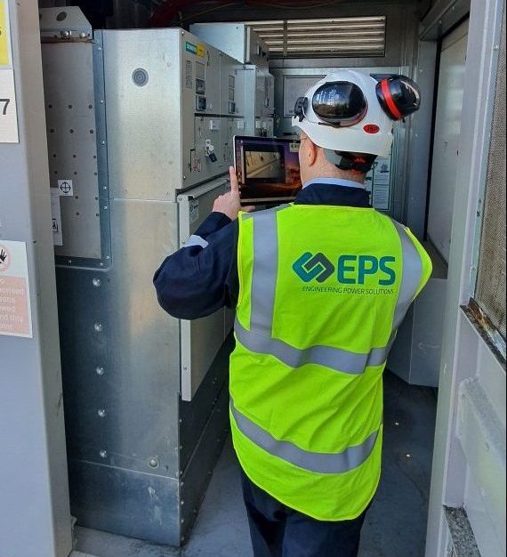 An EPS consultant conducting field tests at battery energy storage facility for grid code compliance studies.