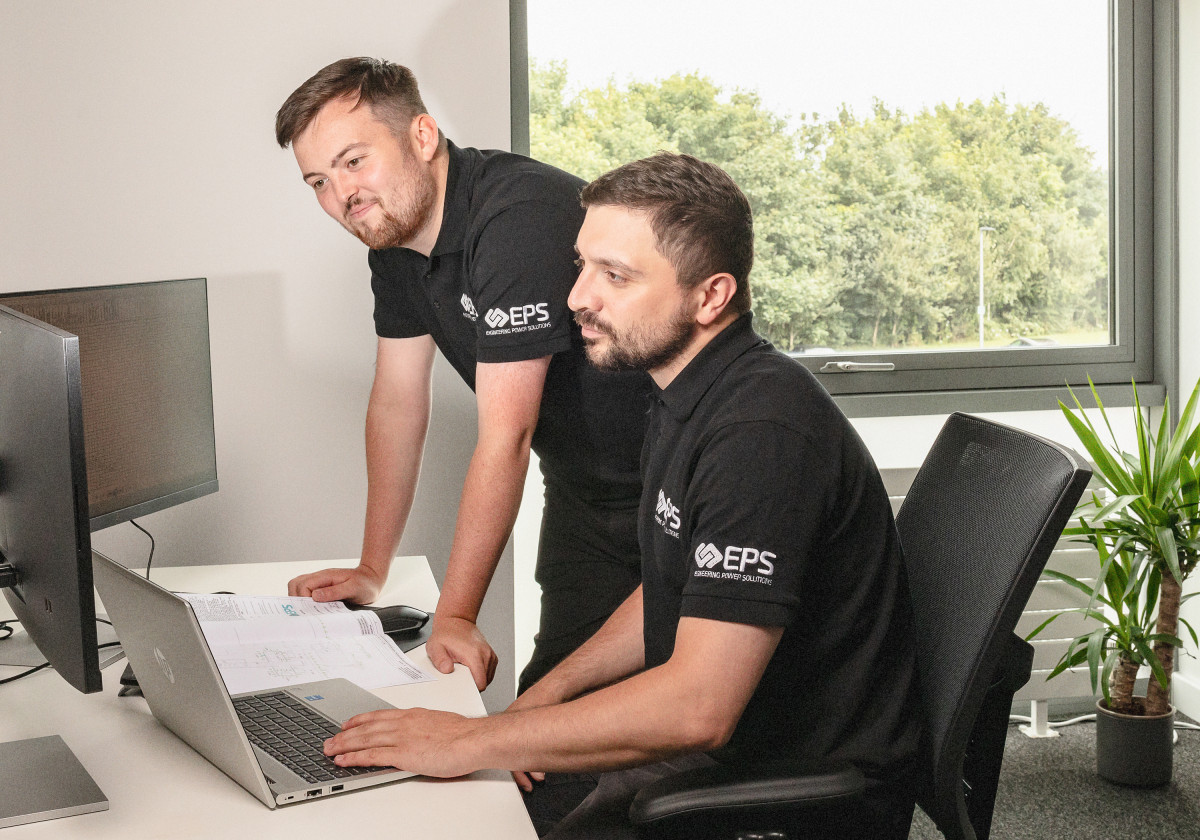 Two EPS electrical engineers conducting a power system study in an office setting.