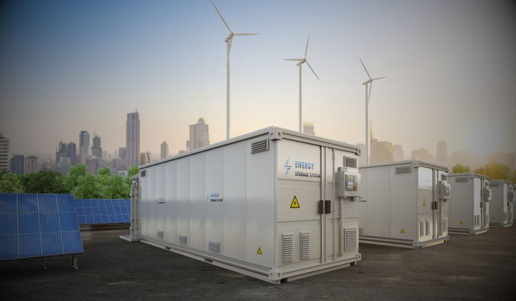 A stock image of renewable energy mix, focusing on a bess facility with the overlayed text "Battery Energy Storage Systems (BESS)"